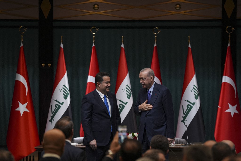 Turkish President Recep Tayyip Erdogan (R) and Iraqi Prime Minister Mohammed Shia' Al-Sudani (L) hold a signing ceremony during joint press conference following a bilateral and delegation-level meeting at the Presidential Complex in Ankara, Turkiye on May 08, 2025. Turkiye and Iraq signed agreements in a range of fields including migration, education, counter-narcotics, disaster and emergency management, information and communication technologies, defense industry, higher education, metrology, and law (Photo by Muhammed Selim Korkutata / Anadolu via AFP).