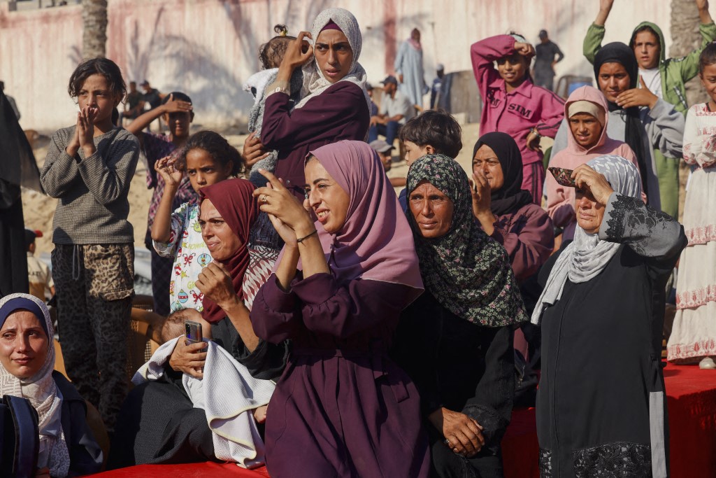 People gather to welcome Palestinians released from Israeli prisons under a Gaza ceasefire and hostage exchange deal with Palestinian factions, as the buses carrying them arrives outside the Nasser hospital in Khan Yunis in the southern Gaza Strip on October 13, 2025. (Photo by Abdelrahman Rashad / Middle East Images via AFP)